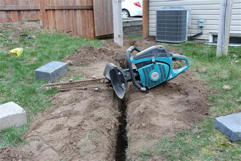 digging a trench with a mini excavator|small held handheld trenchers.